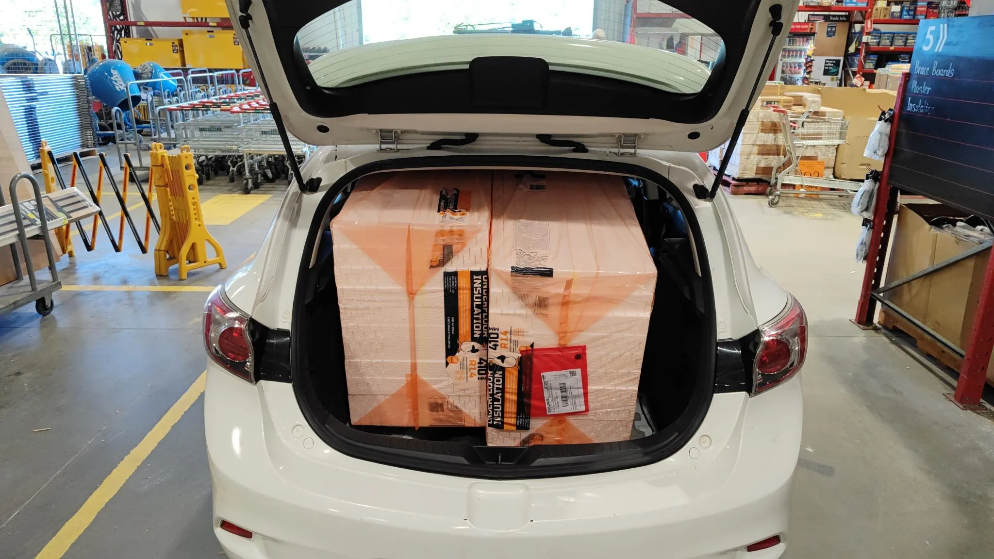 Two insulation packs crammed into the car boot